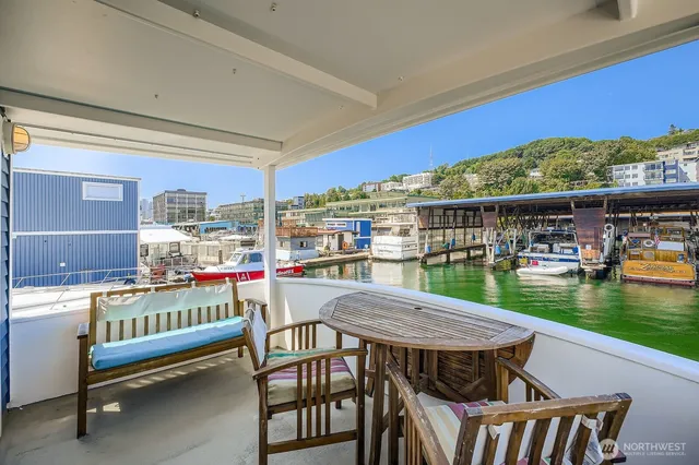 a view of a chairs and table in patio with a swimming pool