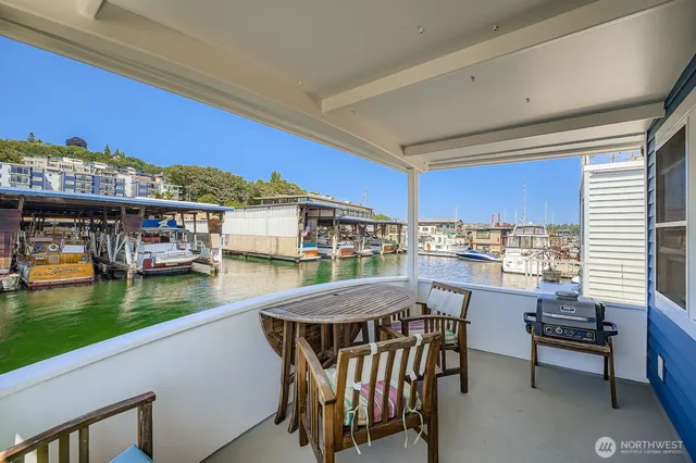 a view of a chairs and table in patio with a lake view
