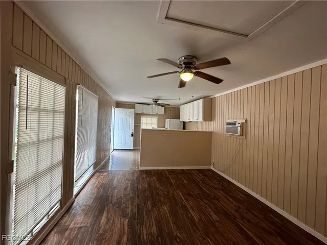 a view of a livingroom with a ceiling fan and hardwood floor