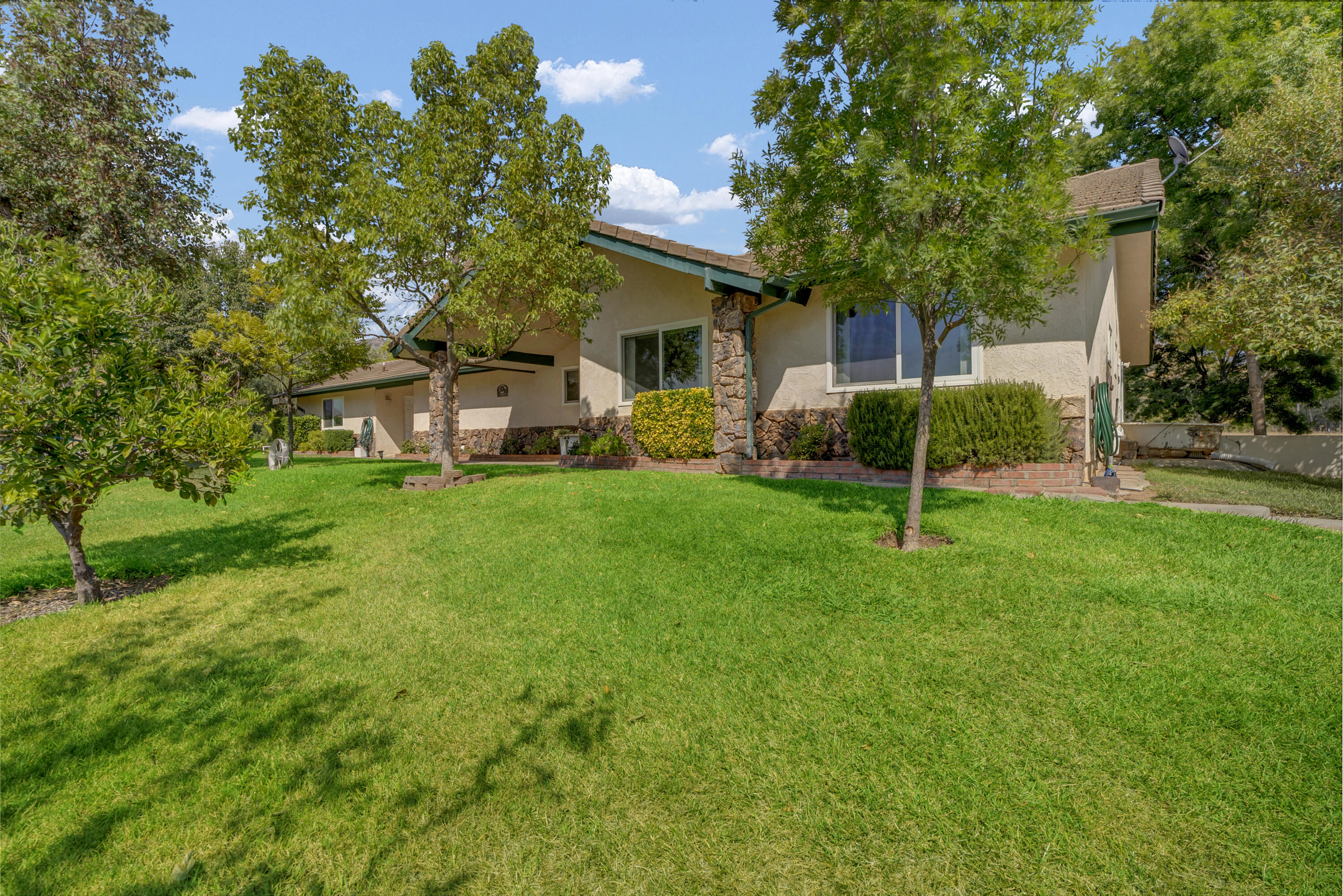 18002 320th Road Springville, CA 93265 - Photo 6 of 56 a view of a house with a backyard and a tree