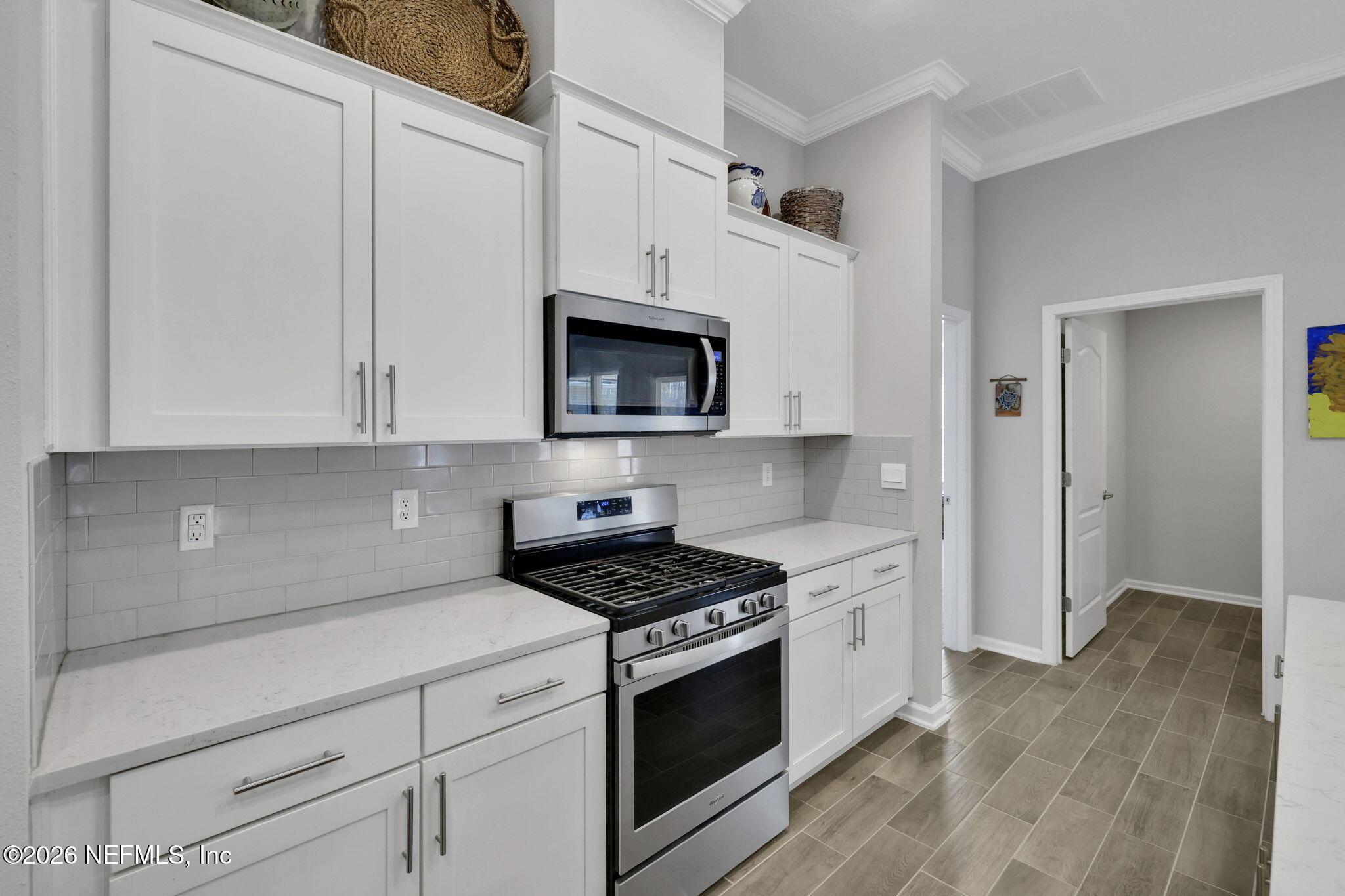 84 Cardinal Branch Lane St. Augustine, FL 32095 - Photo 13 of 45 a kitchen with white cabinets and stainless steel appliances