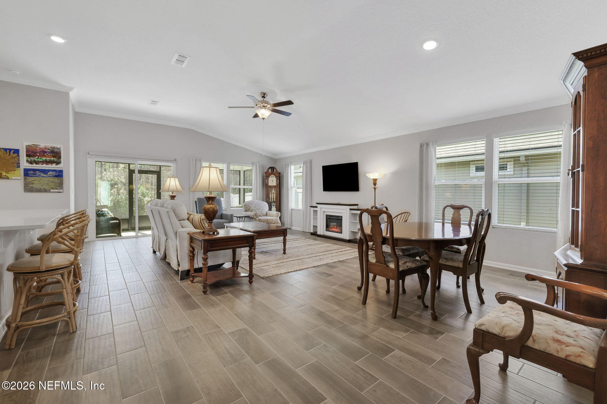 84 Cardinal Branch Lane St. Augustine, FL 32095 - Photo 23 of 45 a living room with furniture a dining table and a floor to ceiling window