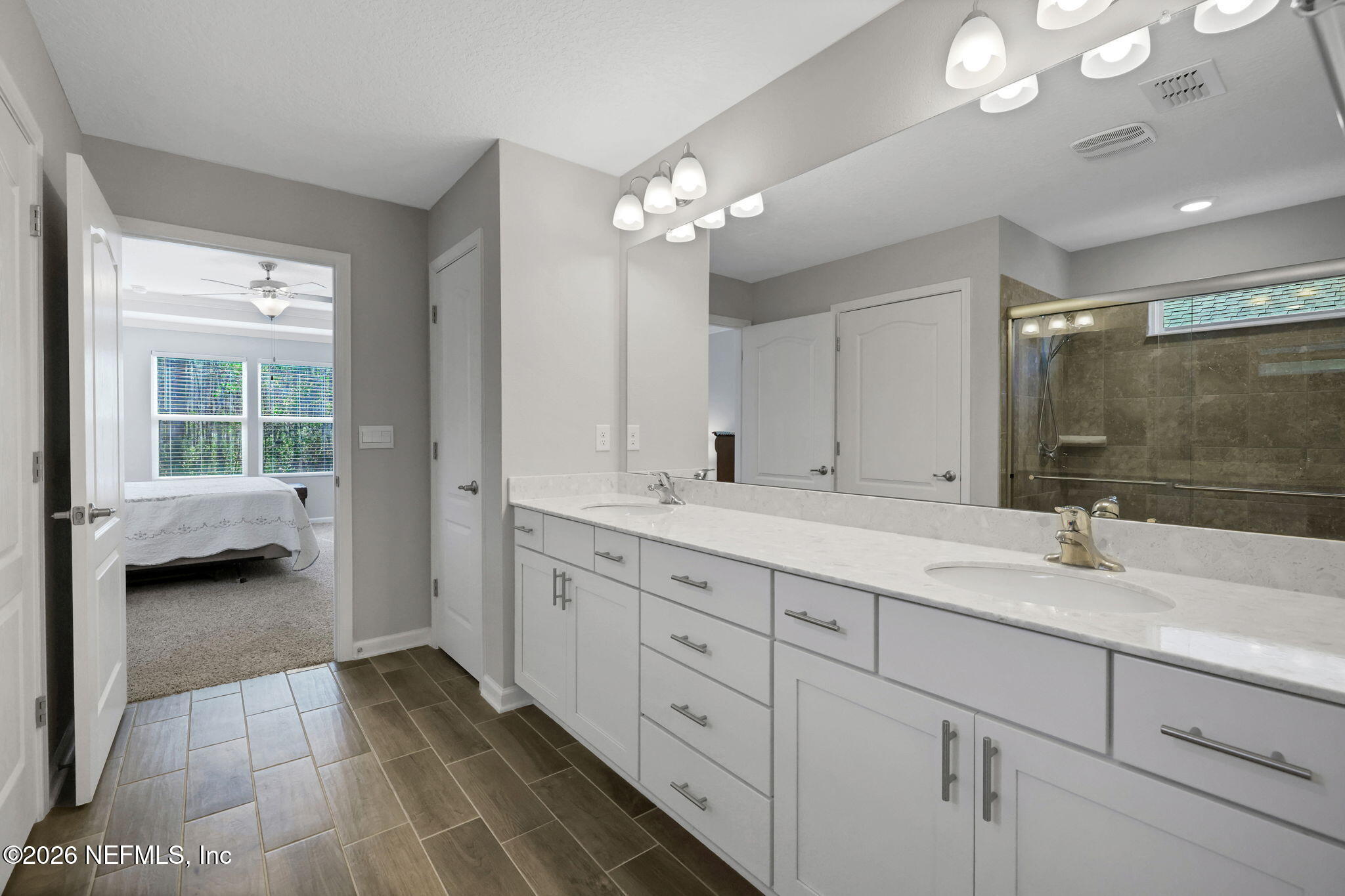 84 Cardinal Branch Lane St. Augustine, FL 32095 - Photo 28 of 45 a bathroom with a double vanity sink and a mirror