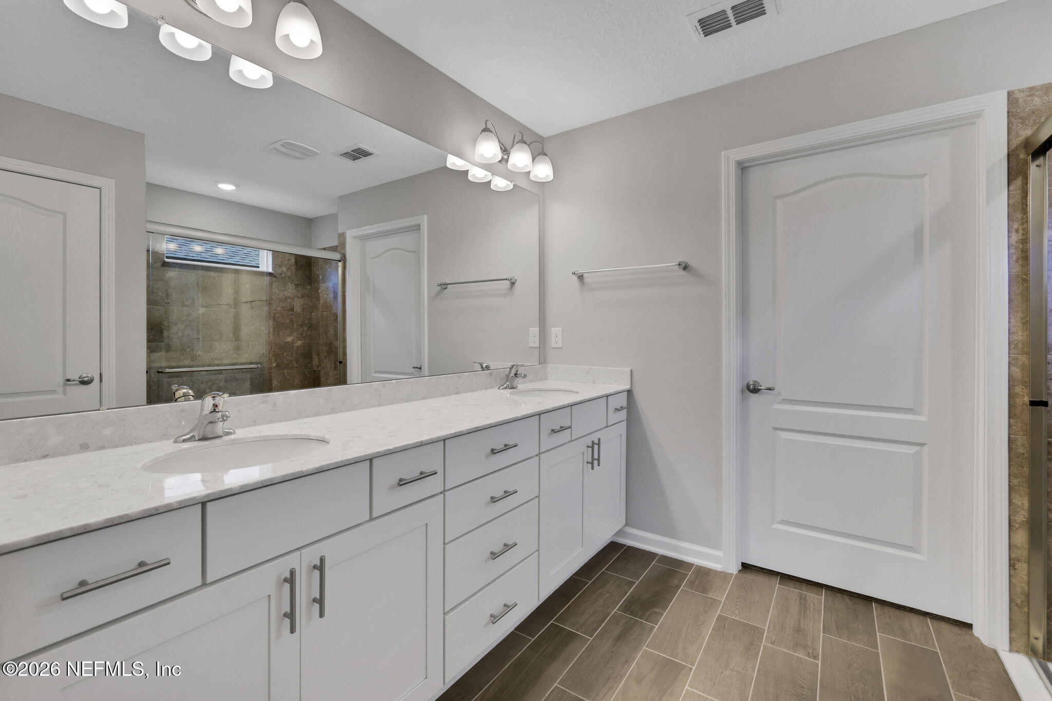 84 Cardinal Branch Lane St. Augustine, FL 32095 - Photo 29 of 45 a bathroom with a double vanity sink and a mirror