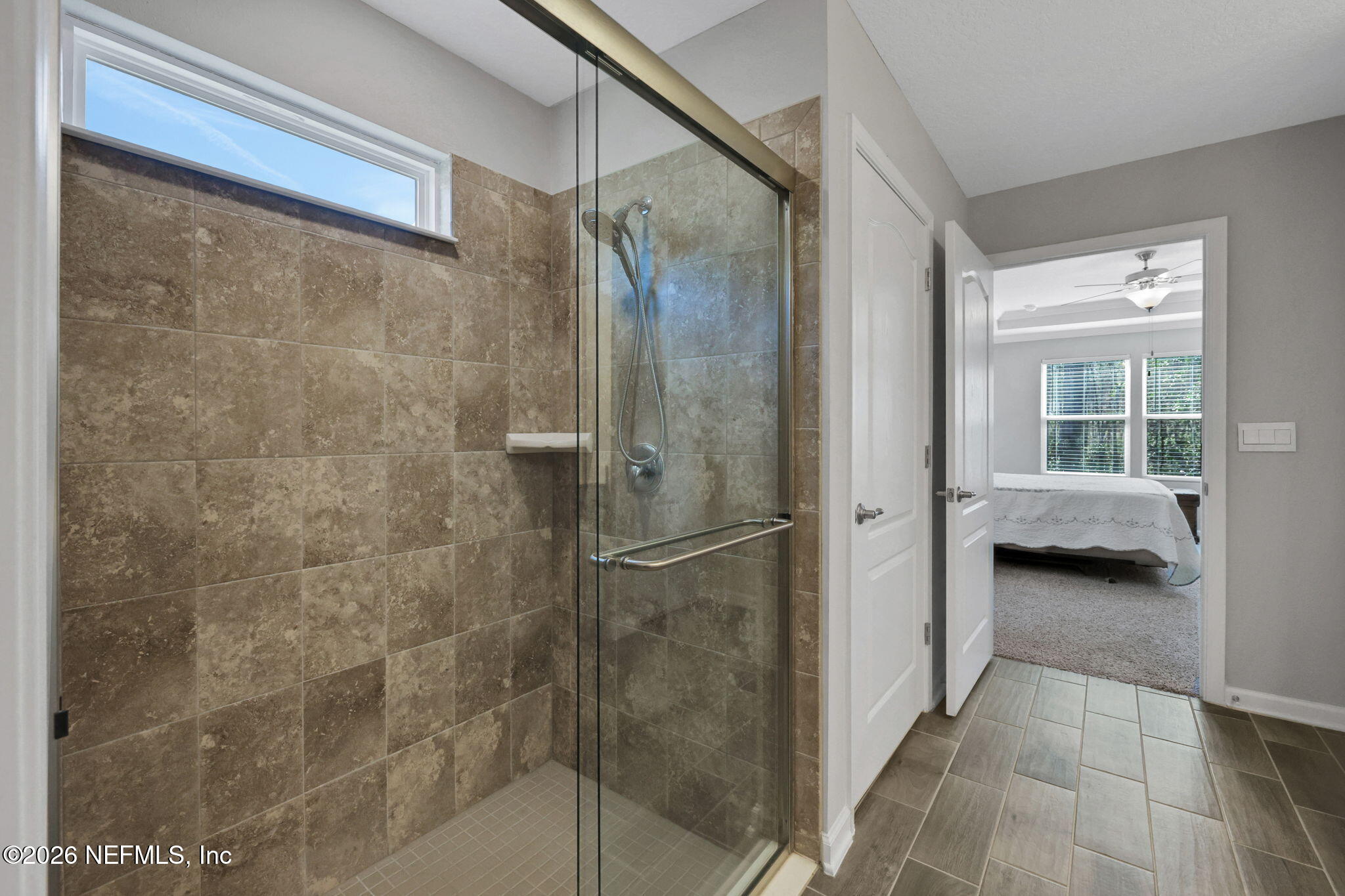 84 Cardinal Branch Lane St. Augustine, FL 32095 - Photo 31 of 45 a bathroom with a granite countertop shower a sink and a window