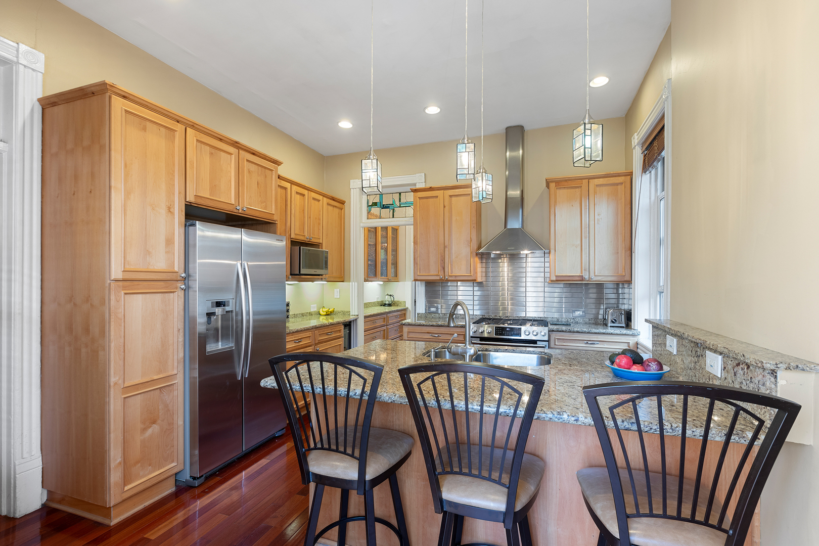 929 West Fletcher Street Chicago, IL 60657 - Photo 13 of 53 a kitchen with stainless steel appliances granite countertop a stove a refrigerator a dining table and chairs