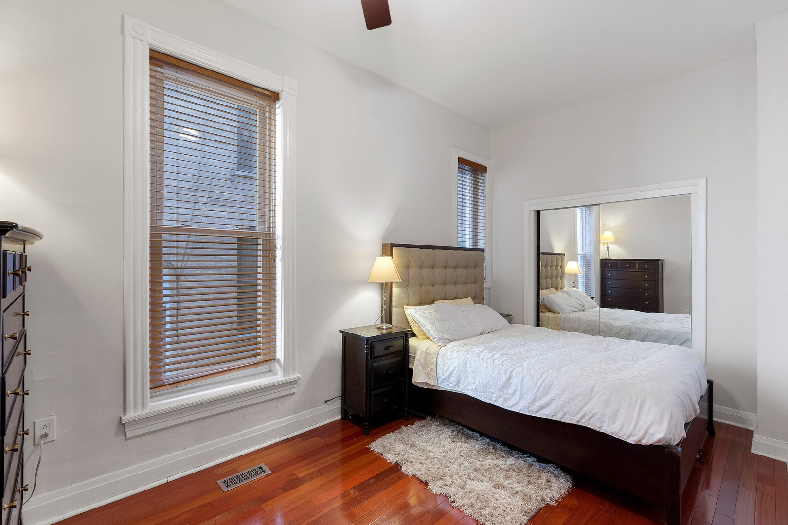 929 West Fletcher Street Chicago, IL 60657 - Photo 18 of 53 a bedroom with a bed and wooden floor