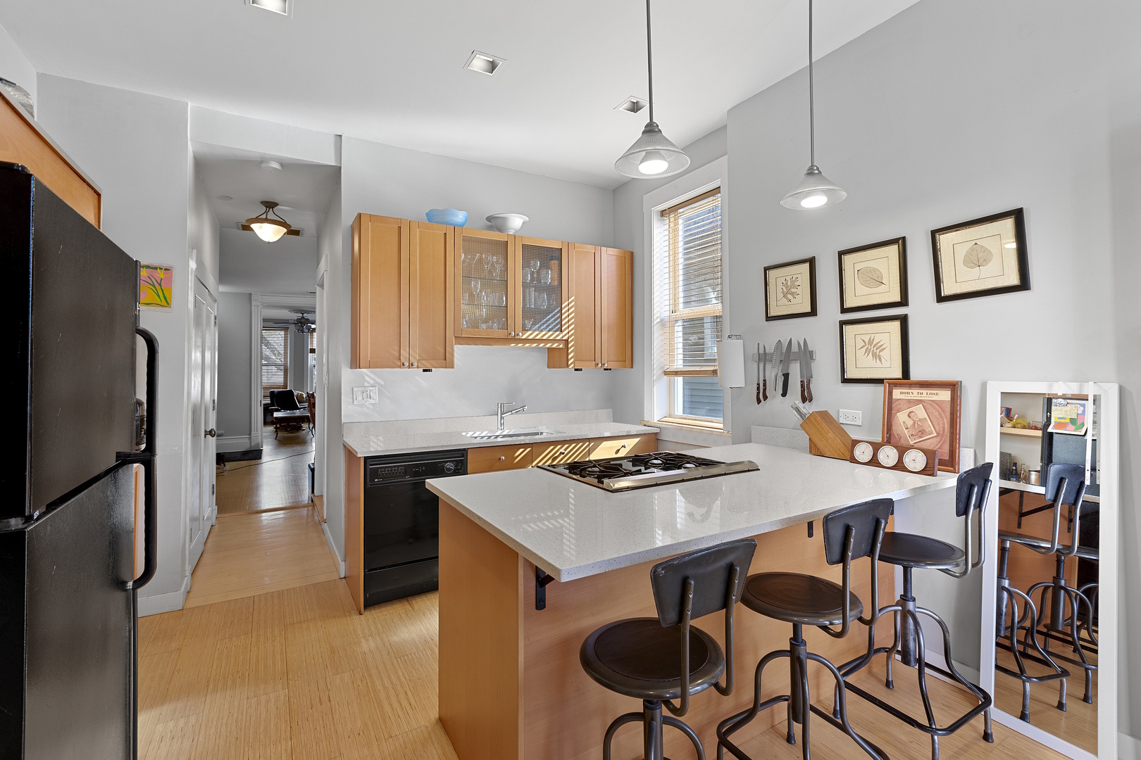 929 West Fletcher Street Chicago, IL 60657 - Photo 34 of 53 a kitchen with stainless steel appliances granite countertop a stove refrigerator a dining table and chairs with wooden floor