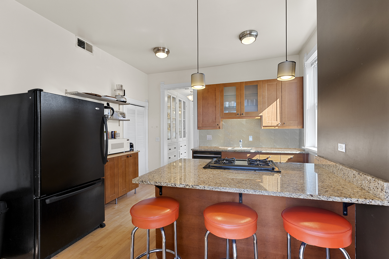 929 West Fletcher Street Chicago, IL 60657 - Photo 44 of 53 a kitchen with stainless steel appliances granite countertop a stove refrigerator and chair