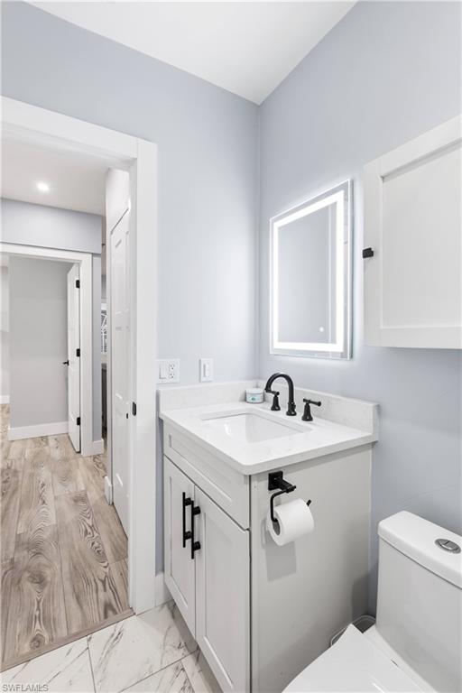 940 3rd Street South, Unit 204 Naples, FL 34102 - Photo 13 of 25 a bathroom with a sink toilet and mirror