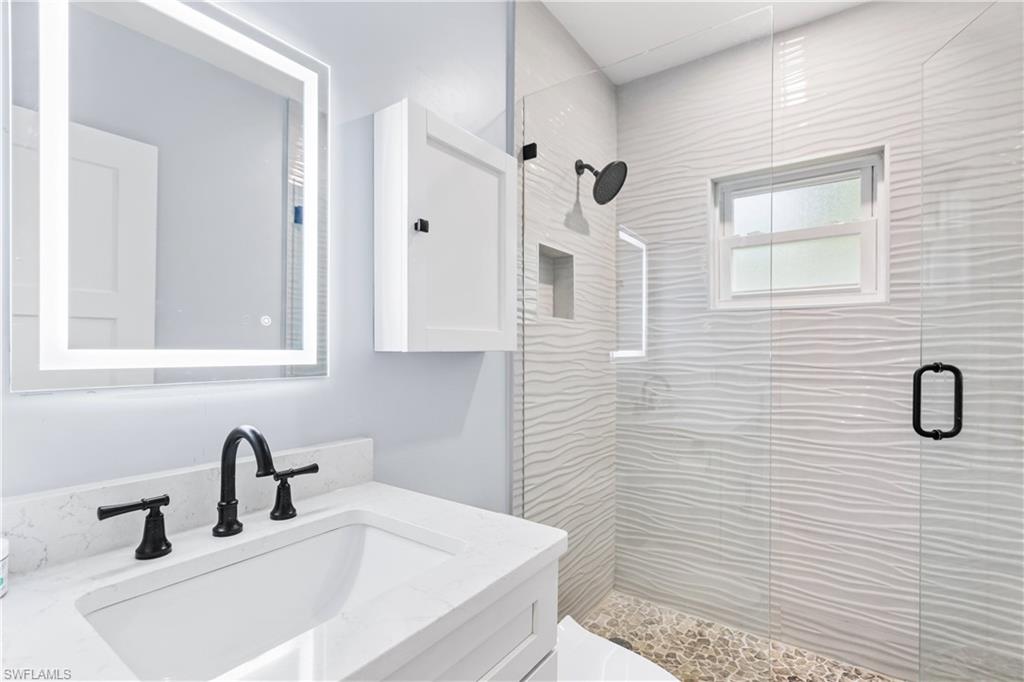 940 3rd Street South, Unit 204 Naples, FL 34102 - Photo 14 of 25 a bathroom with a sink and a mirror