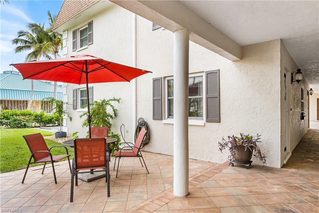 940 3rd Street South, Unit 204 Naples, FL 34102 - Photo 19 of 25 a view of a house with backyard sitting area and garden