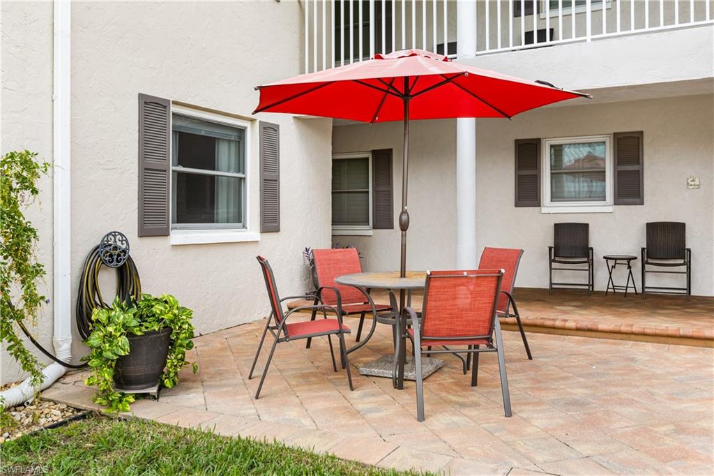 940 3rd Street South, Unit 204 Naples, FL 34102 - Photo 20 of 25 a view of a house with a yard and sitting area