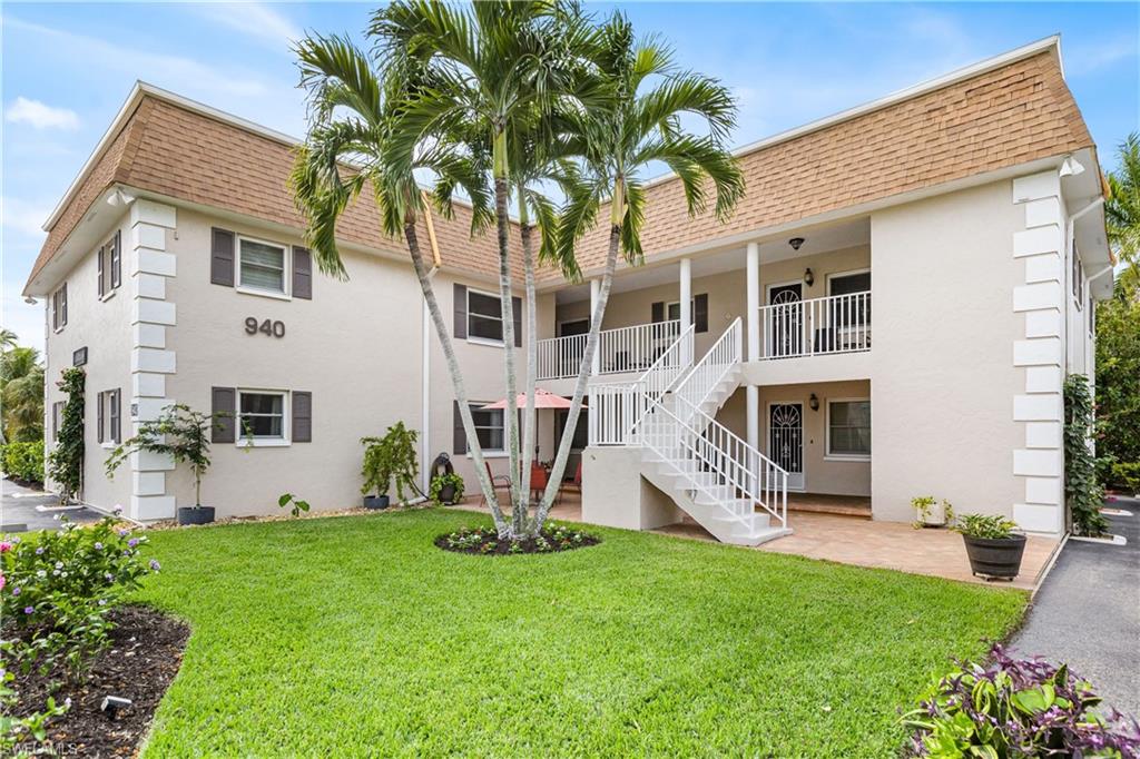 940 3rd Street South, Unit 204 Naples, FL 34102 - Photo 21 of 25 a front view of a house with a garden and plants