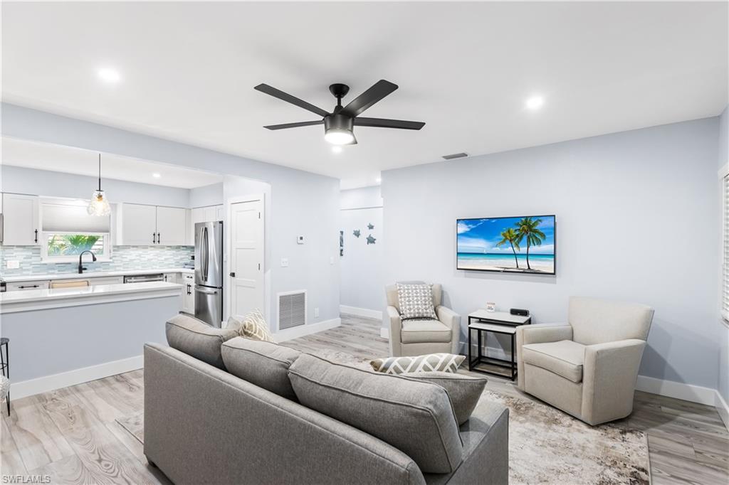 940 3rd Street South, Unit 204 Naples, FL 34102 - Photo 6 of 25 a living room with furniture and a view of kitchen