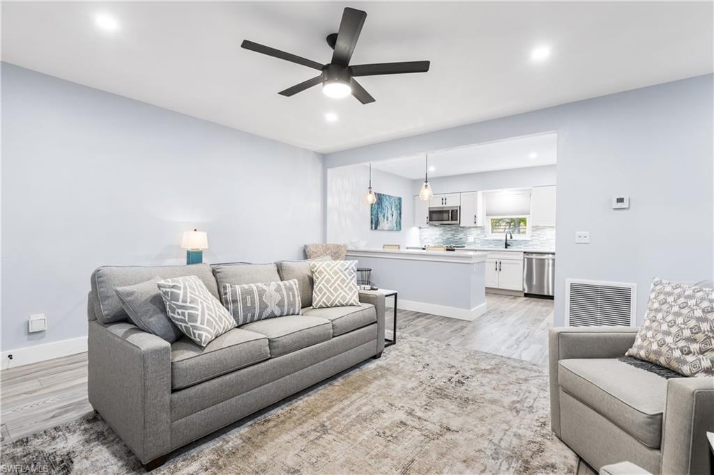 940 3rd Street South, Unit 204 Naples, FL 34102 - Photo 7 of 25 a living room with furniture and kitchen view