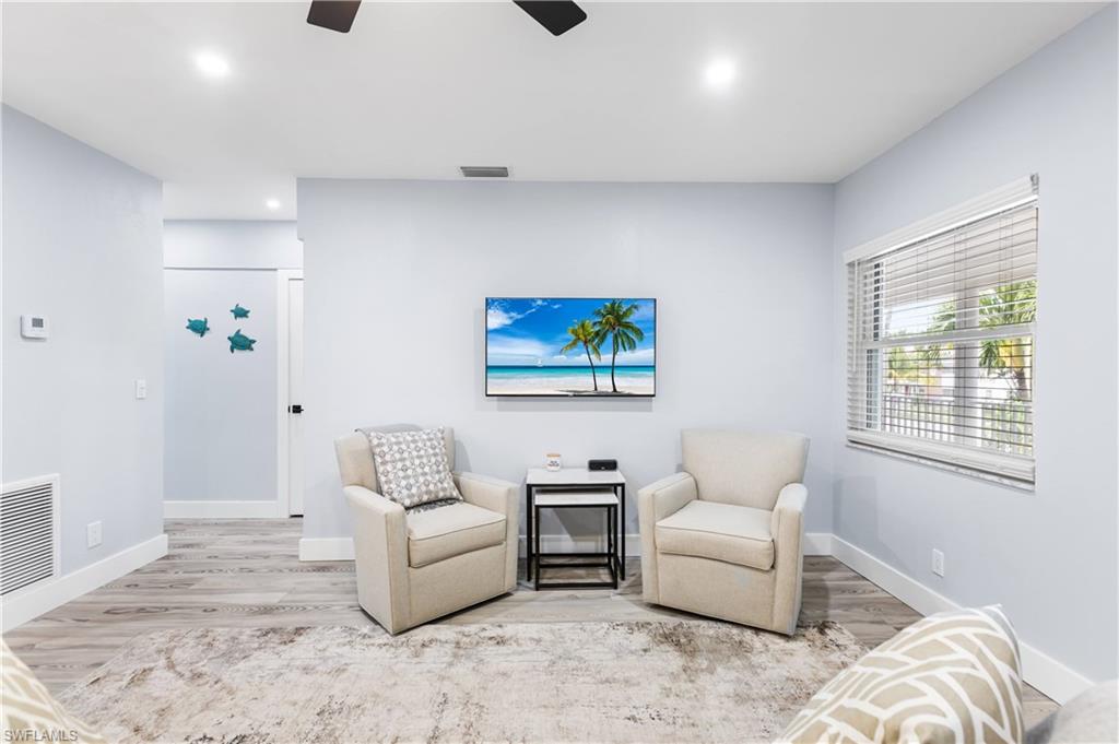 940 3rd Street South, Unit 204 Naples, FL 34102 - Photo 9 of 25 a living room with furniture and a window