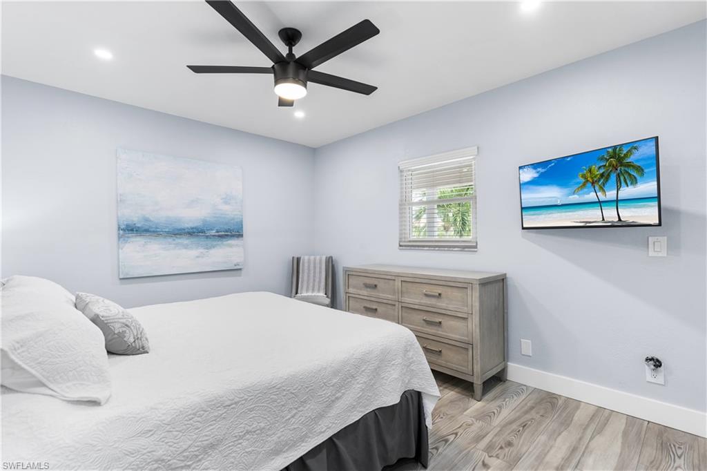940 3rd Street South, Unit 204 Naples, FL 34102 - Photo 10 of 25 a bedroom with a bed and a painting on the wall