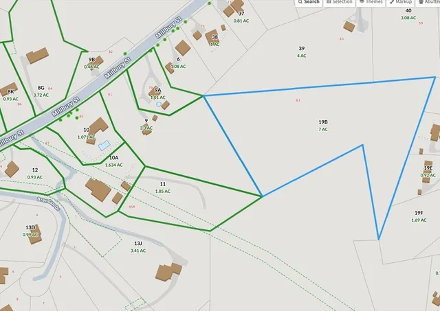 a utility room with white walls and wooden floor