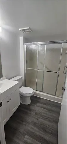 a bathroom with a toilet a sink and shower