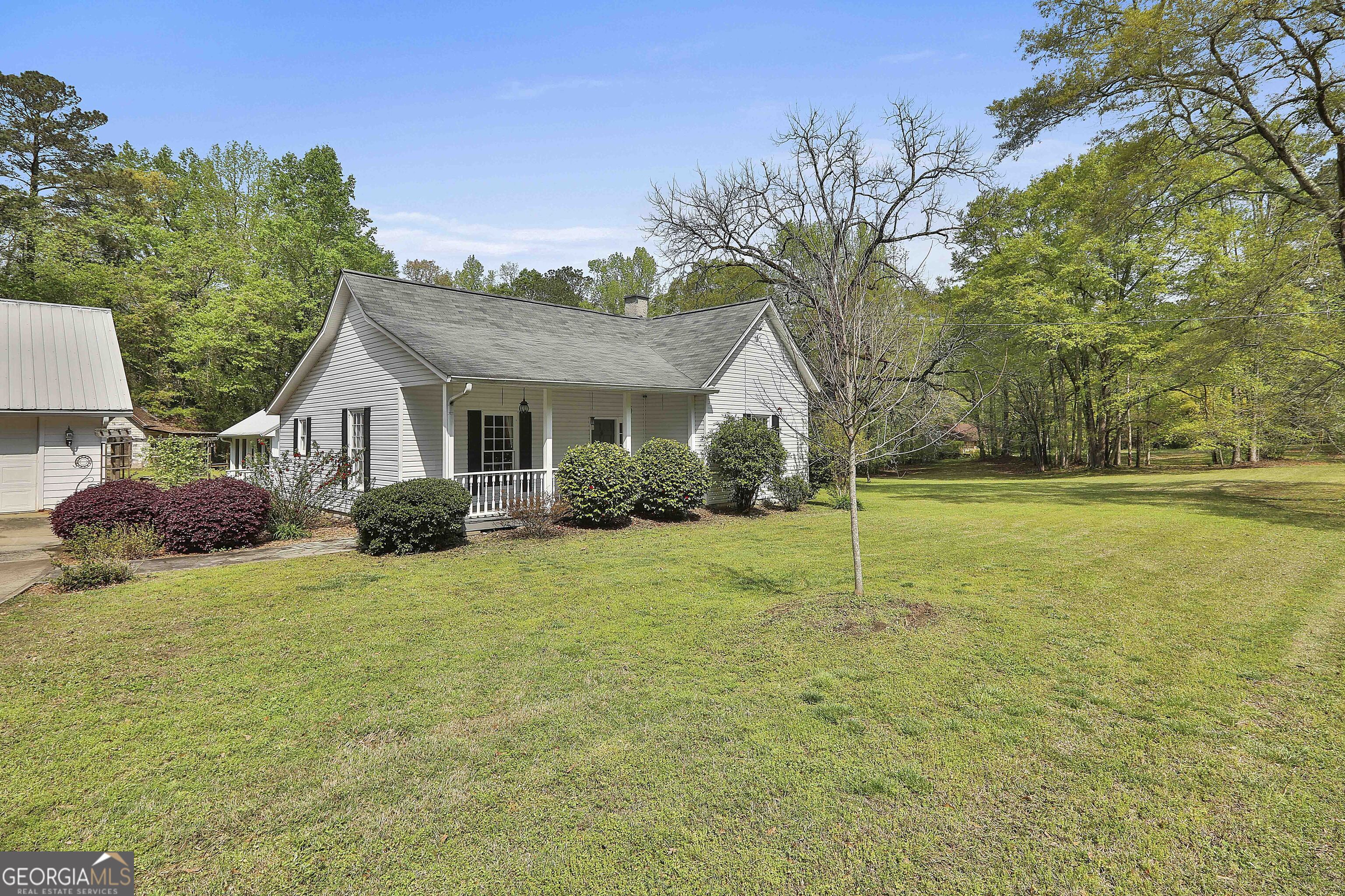 7305 Rico Road Palmetto, GA 30268 - Photo 1 of 1 a view of a house with backyard and trees