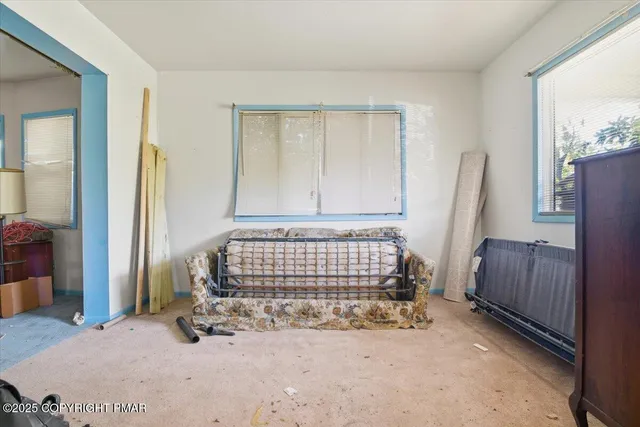 a bedroom with bed and a large mirror