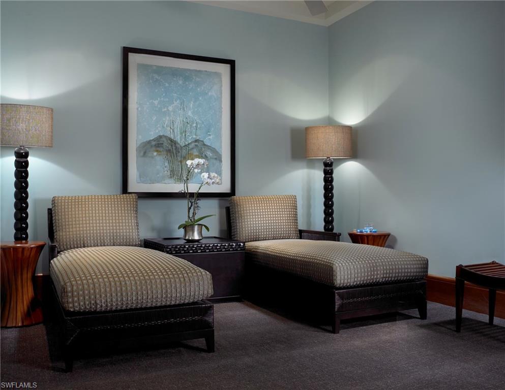 13675 Vanderbilt Drive, Unit 510 Naples, FL 34110 - Photo 21 of 25 a bedroom with a bed lamp and paintings on the wall