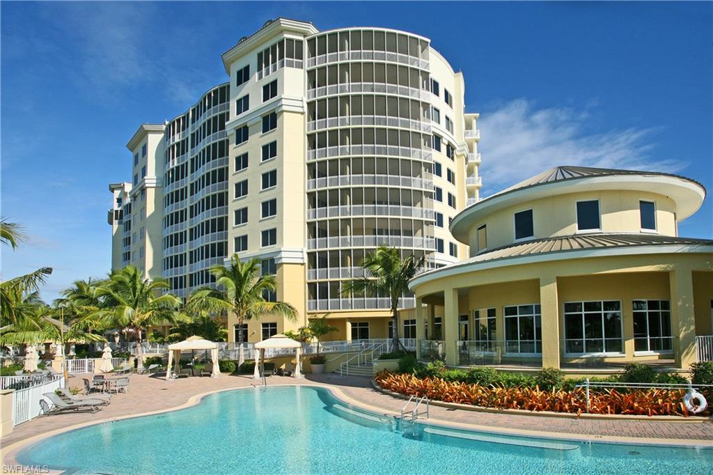 13675 Vanderbilt Drive, Unit 510 Naples, FL 34110 - Photo 25 of 25 front view of a building with a garden
