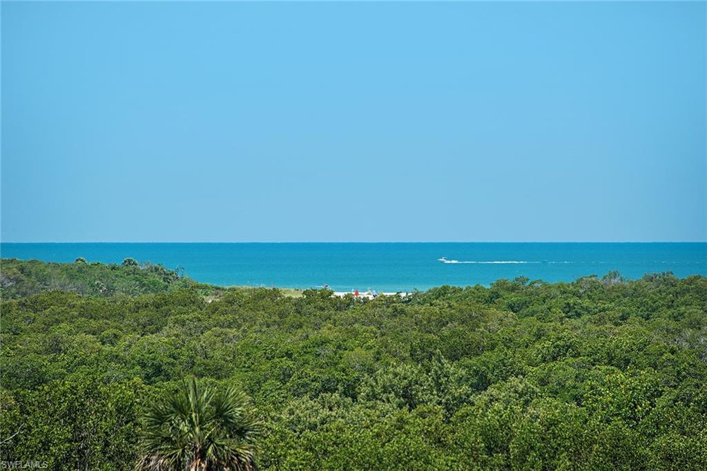 13675 Vanderbilt Drive, Unit 510 Naples, FL 34110 - Photo 5 of 25 an aerial view of residential houses with outdoor space and trees