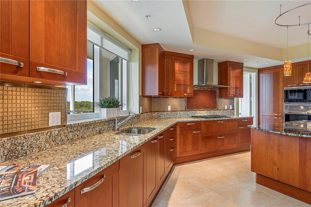 13675 Vanderbilt Drive, Unit 510 Naples, FL 34110 - Photo 6 of 25 a large kitchen with granite countertop a sink and dishwasher a large window
