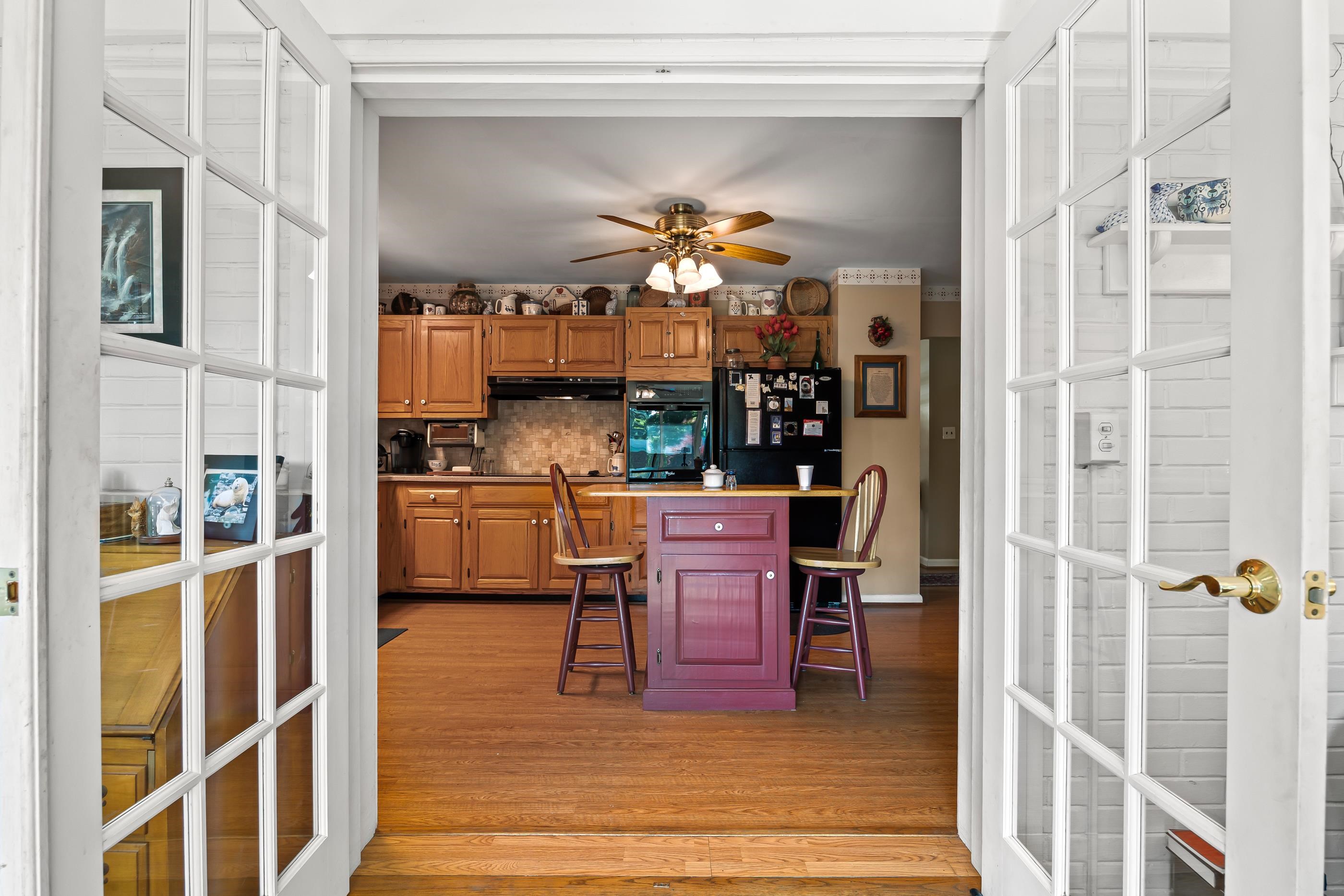 208 Tuxedo Road Staunton, VA 24401 - Photo 12 of 46 a view of a dining room with furniture a chandelier and wooden floor