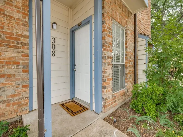a view of wooden door and brick wall