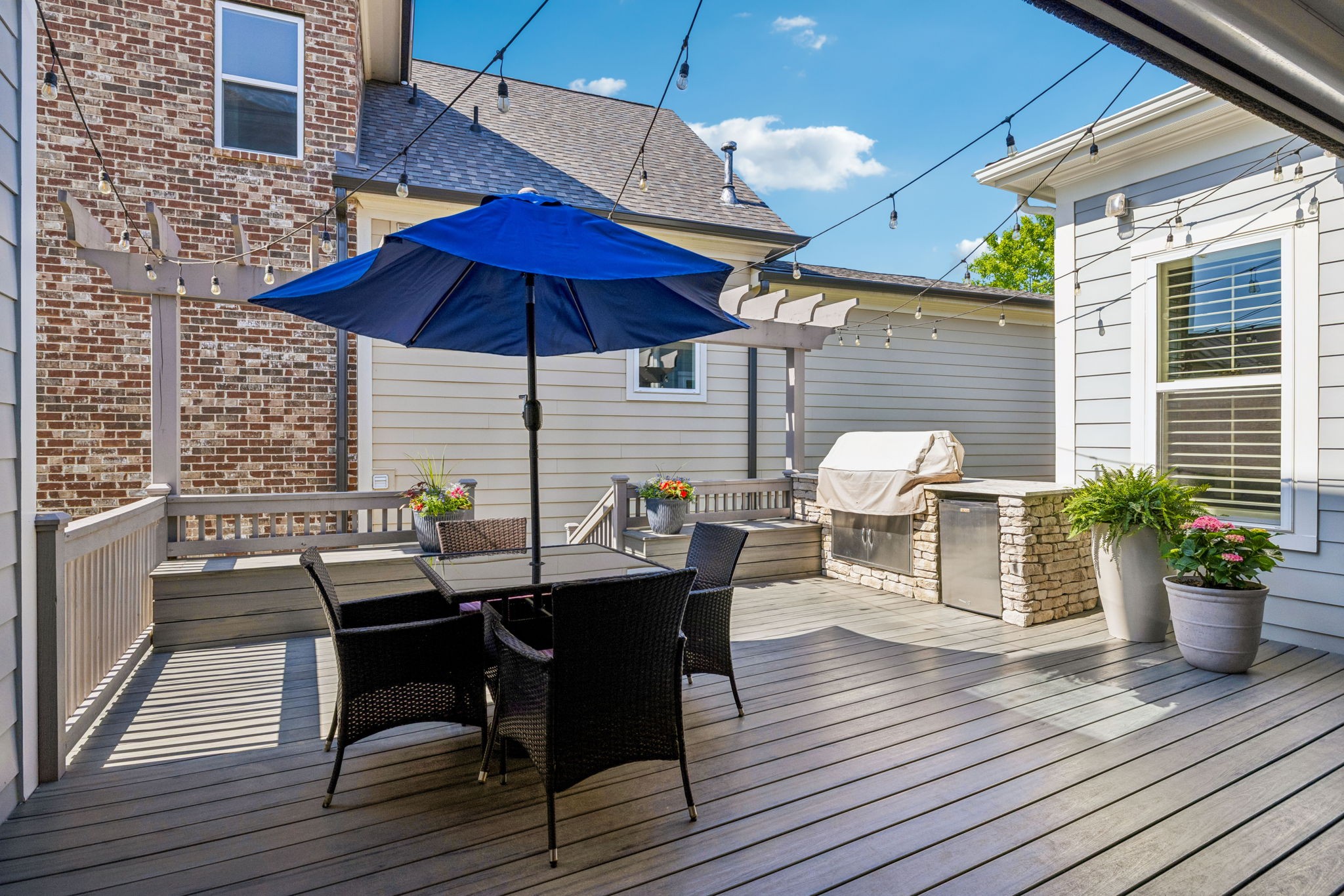 8024 Keats Street Franklin, TN 37064 - Photo 16 of 42 a view of a roof deck with table and chairs under an umbrella