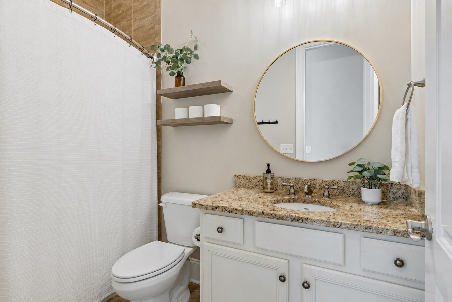 8024 Keats Street Franklin, TN 37064 - Photo 24 of 42 a bathroom with a granite countertop toilet a sink and a mirror