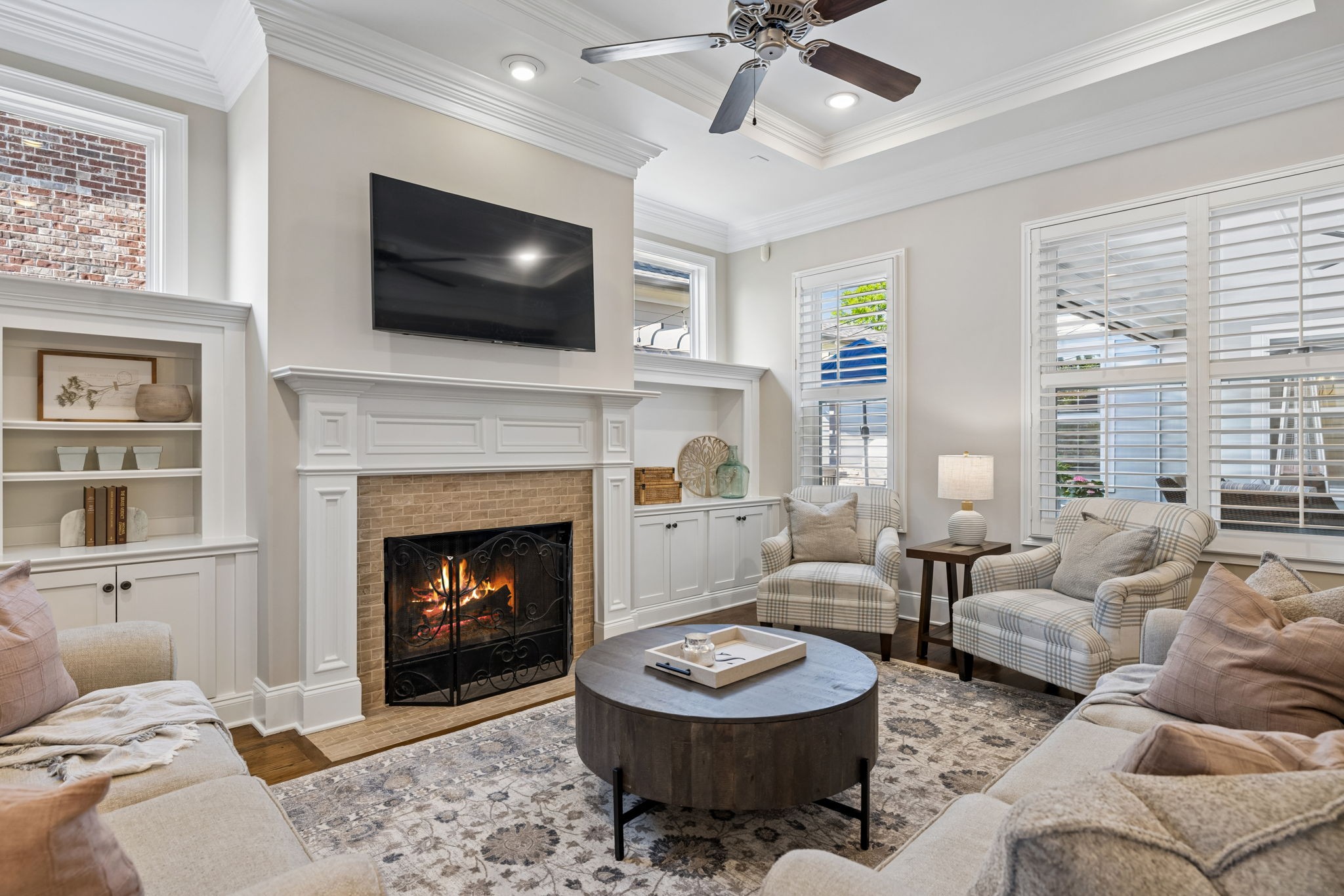 8024 Keats Street Franklin, TN 37064 - Photo 34 of 42 a living room with furniture a fireplace and a flat screen tv