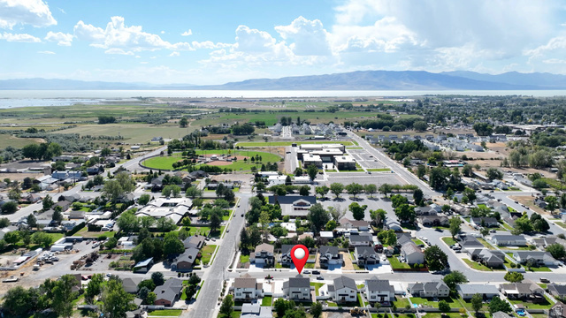 983 South 950 West Provo, UT 84601 - Photo 53 of 56 Aerial view showcasing a residential area with a prominent body of water and distant mountains