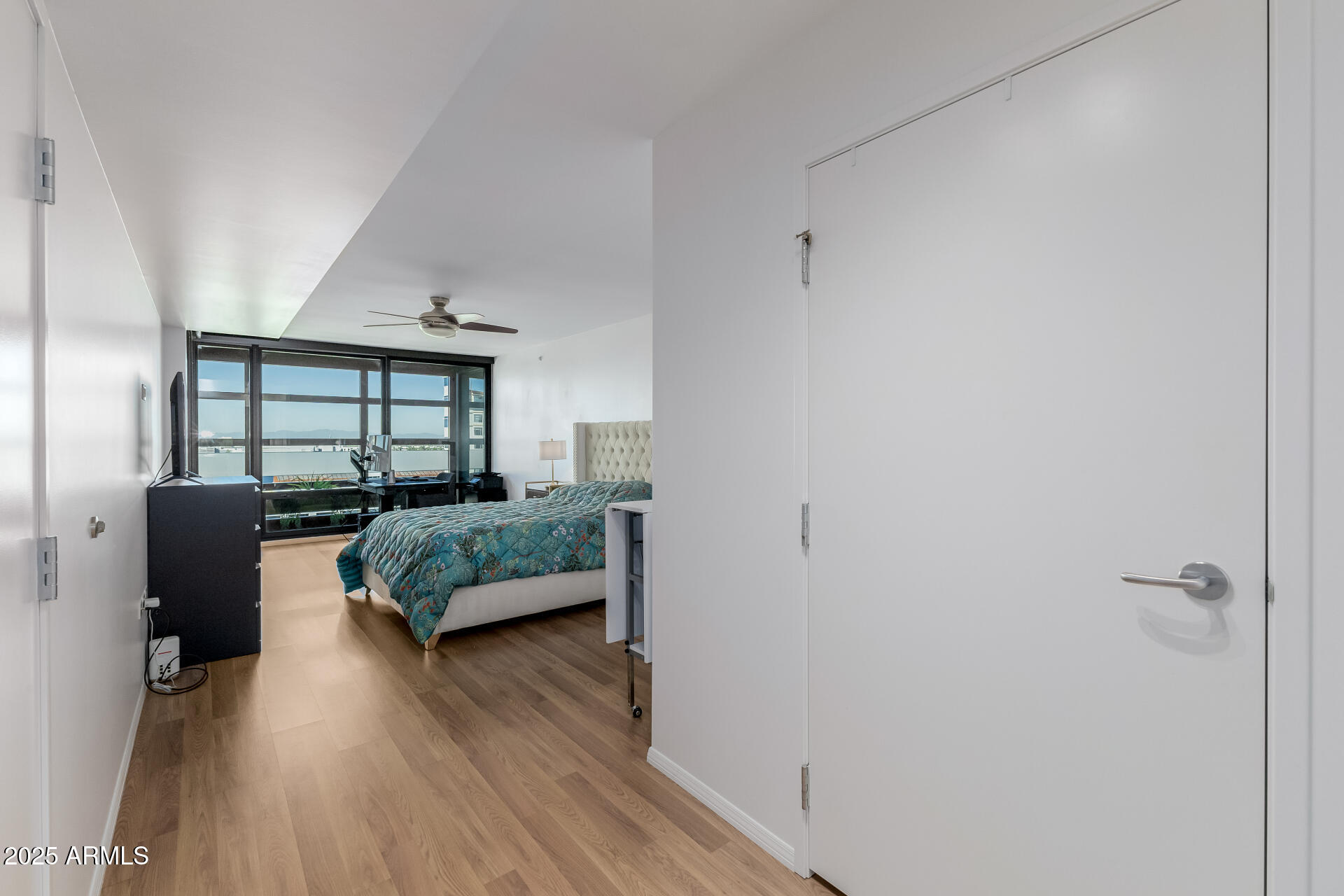 4808 North 24th Street, Unit 1125 Phoenix, AZ 85016 - Photo 22 of 67 a bedroom with a bed and wooden floor