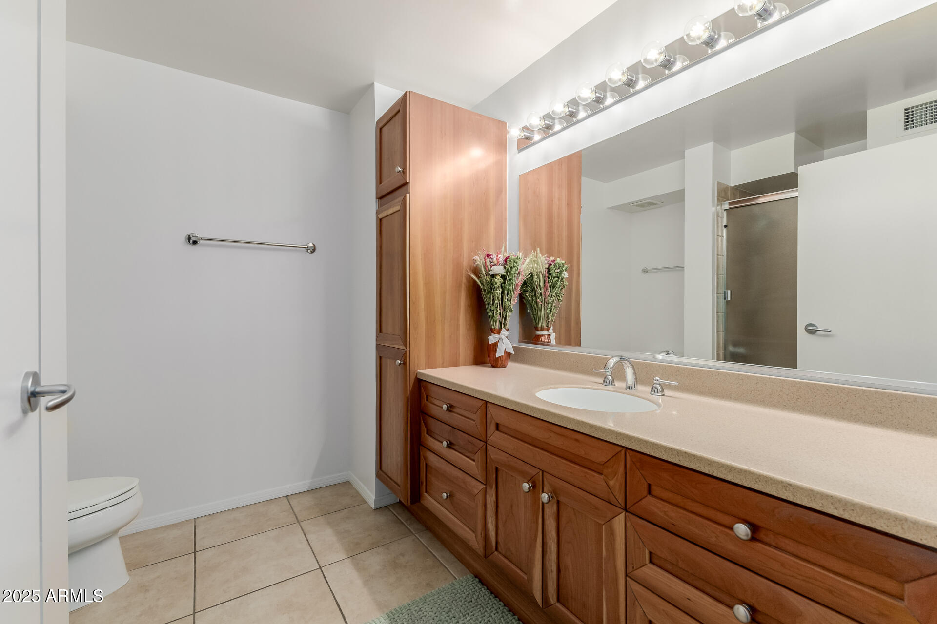4808 North 24th Street, Unit 1125 Phoenix, AZ 85016 - Photo 28 of 67 a spacious bathroom with a granite countertop sink a toilet and a mirror