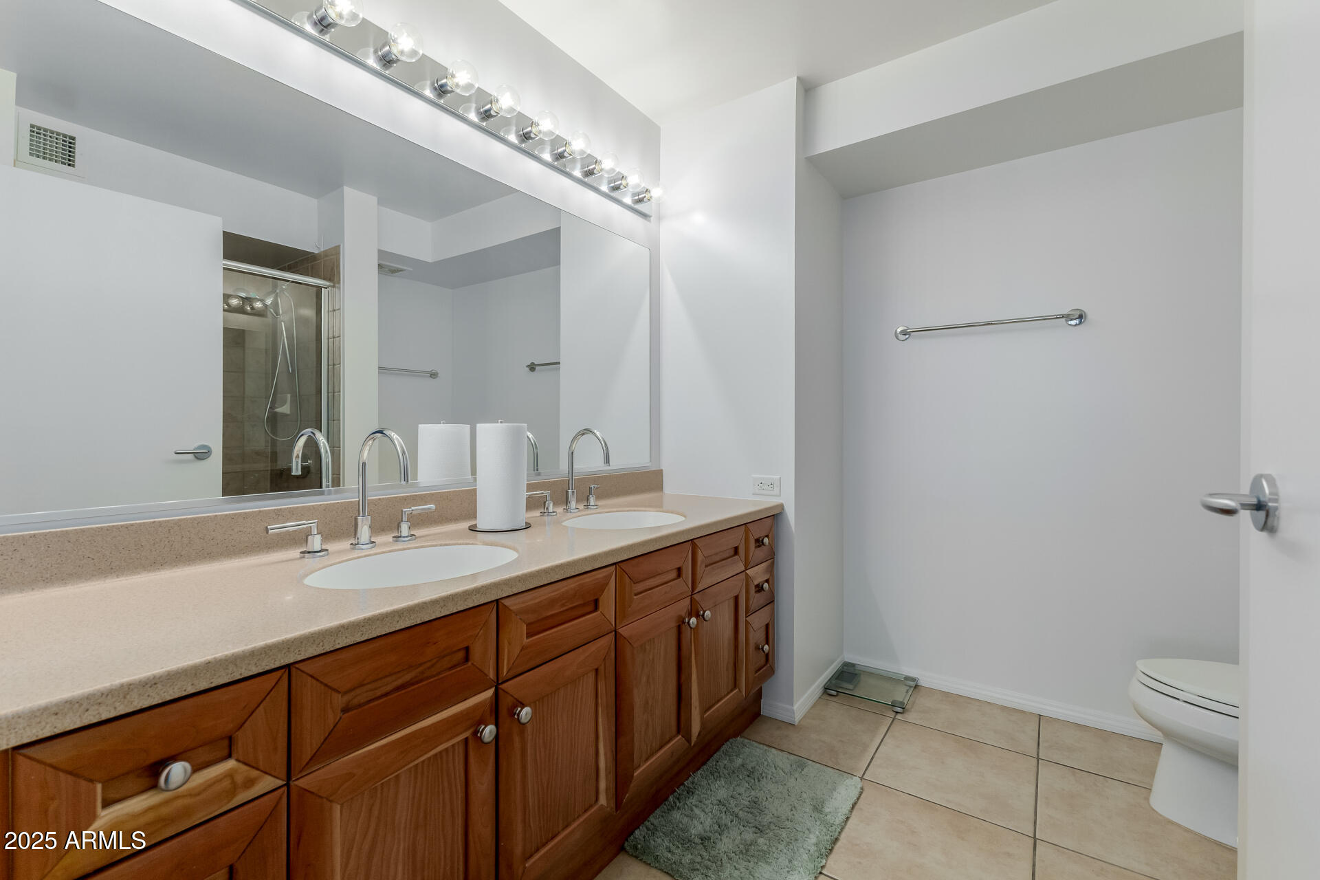 4808 North 24th Street, Unit 1125 Phoenix, AZ 85016 - Photo 34 of 67 a spacious bathroom with a granite countertop sink a toilet and a mirror