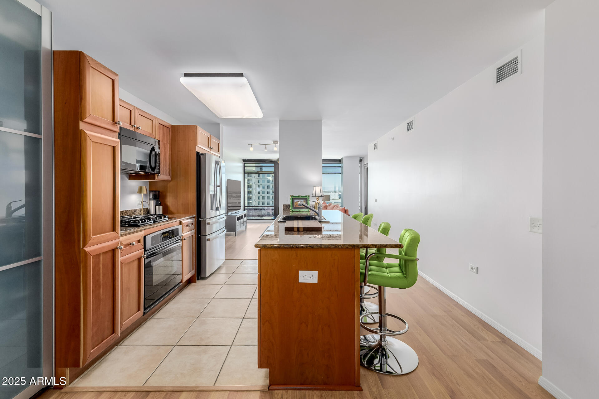 4808 North 24th Street, Unit 1125 Phoenix, AZ 85016 - Photo 4 of 67 a kitchen with stainless steel appliances granite countertop a stove a sink and a refrigerator