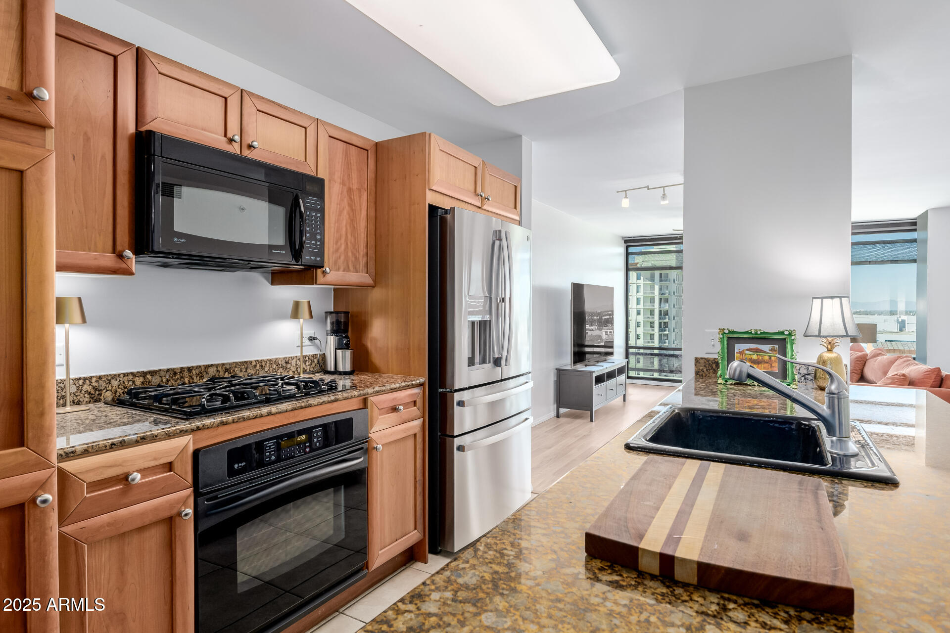 4808 North 24th Street, Unit 1125 Phoenix, AZ 85016 - Photo 7 of 67 a kitchen with granite countertop a sink stove and refrigerator