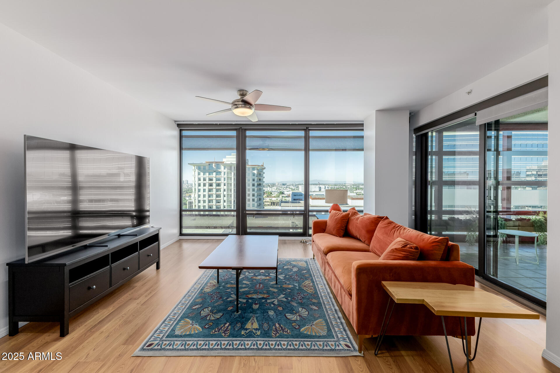 4808 North 24th Street, Unit 1125 Phoenix, AZ 85016 - Photo 10 of 67 a living room with furniture and a floor to ceiling window