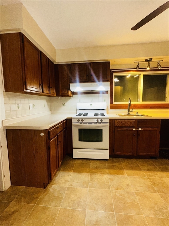 21 Prescott Street, Unit 1 Winthrop, MA 02152 - Photo 11 of 20 a kitchen with stainless steel appliances a stove a sink and a microwave