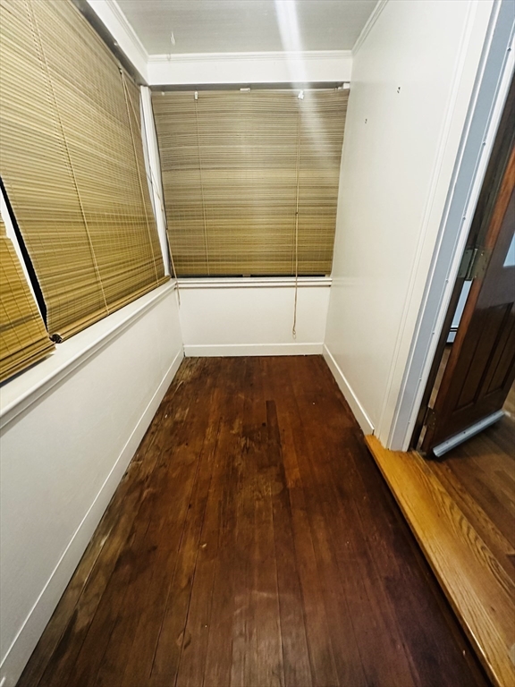 21 Prescott Street, Unit 1 Winthrop, MA 02152 - Photo 14 of 20 a view of a room with wooden floor and door