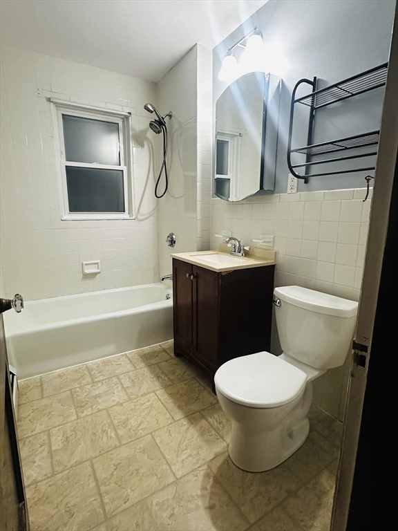 21 Prescott Street, Unit 1 Winthrop, MA 02152 - Photo 17 of 20 a bathroom with a toilet sink and mirror