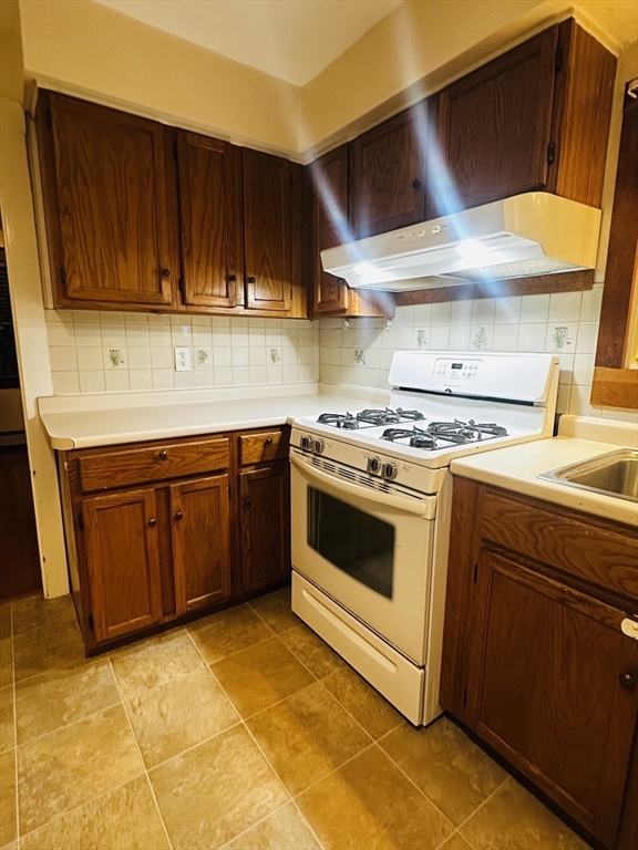 21 Prescott Street, Unit 1 Winthrop, MA 02152 - Photo 20 of 20 a kitchen with a sink stove and cabinets