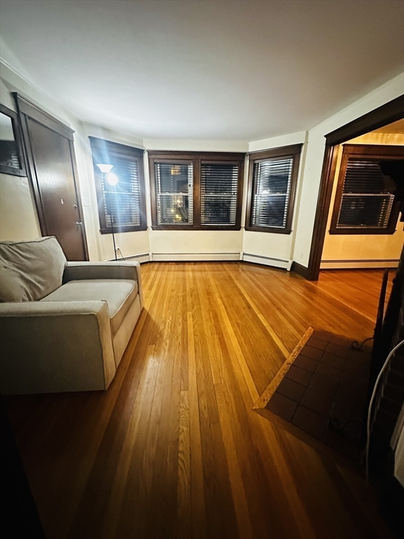 21 Prescott Street, Unit 1 Winthrop, MA 02152 - Photo 4 of 20 a view of an empty room with wooden floor and windows