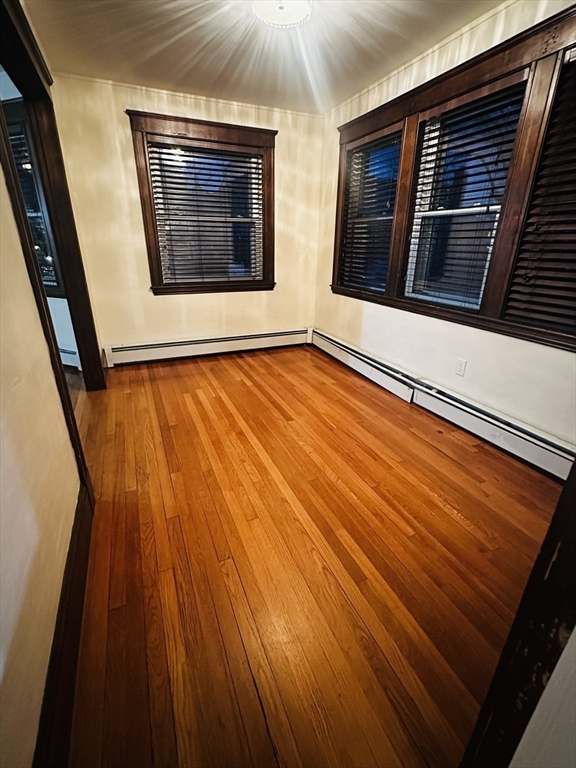 21 Prescott Street, Unit 1 Winthrop, MA 02152 - Photo 5 of 20 a view of an empty room with wooden floor and a window