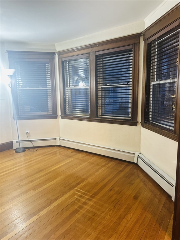 21 Prescott Street, Unit 1 Winthrop, MA 02152 - Photo 6 of 20 a view of an empty room with wooden floor and a window