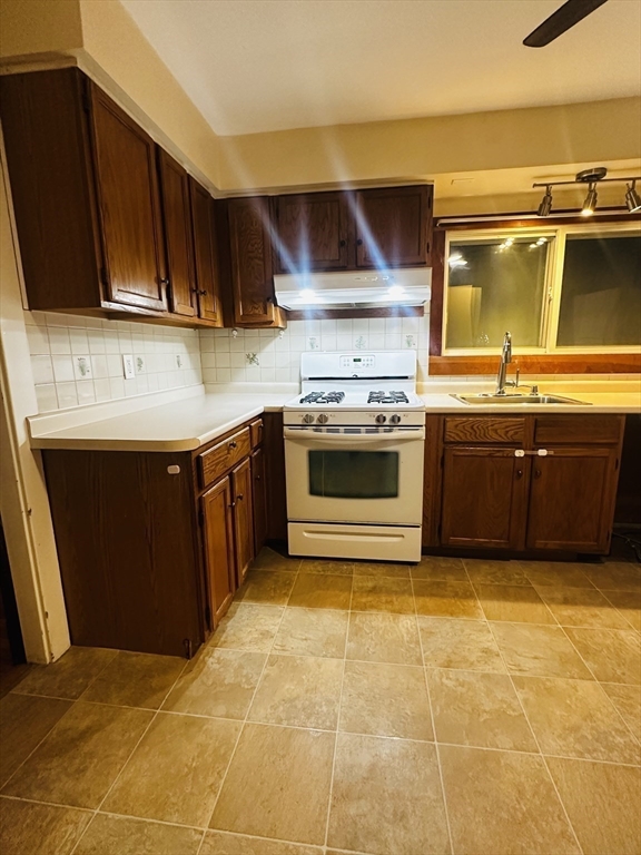 21 Prescott Street, Unit 1 Winthrop, MA 02152 - Photo 10 of 20 a kitchen with stainless steel appliances granite countertop a stove and a sink